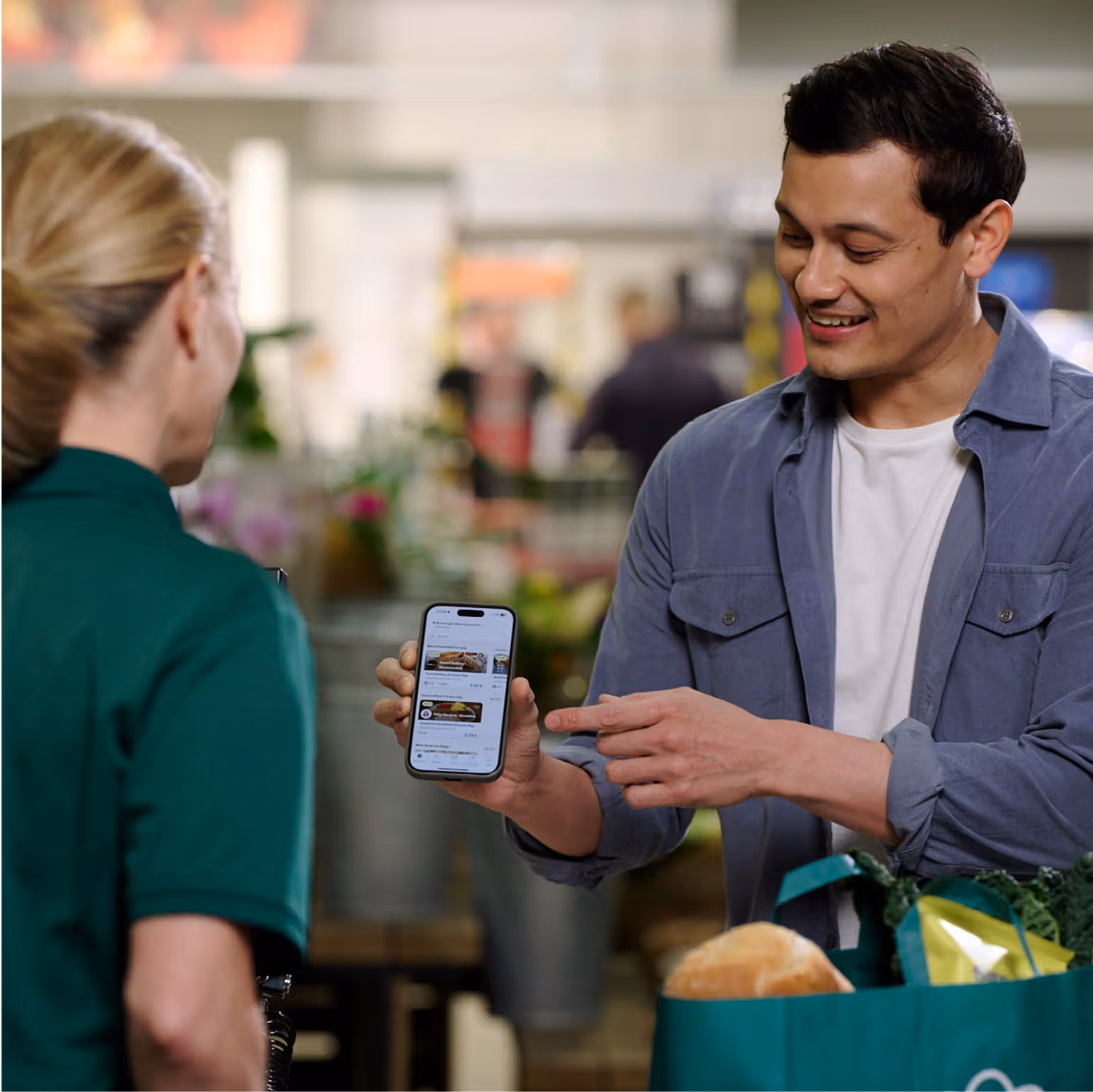 a man is holding a cell phone with a menu on it