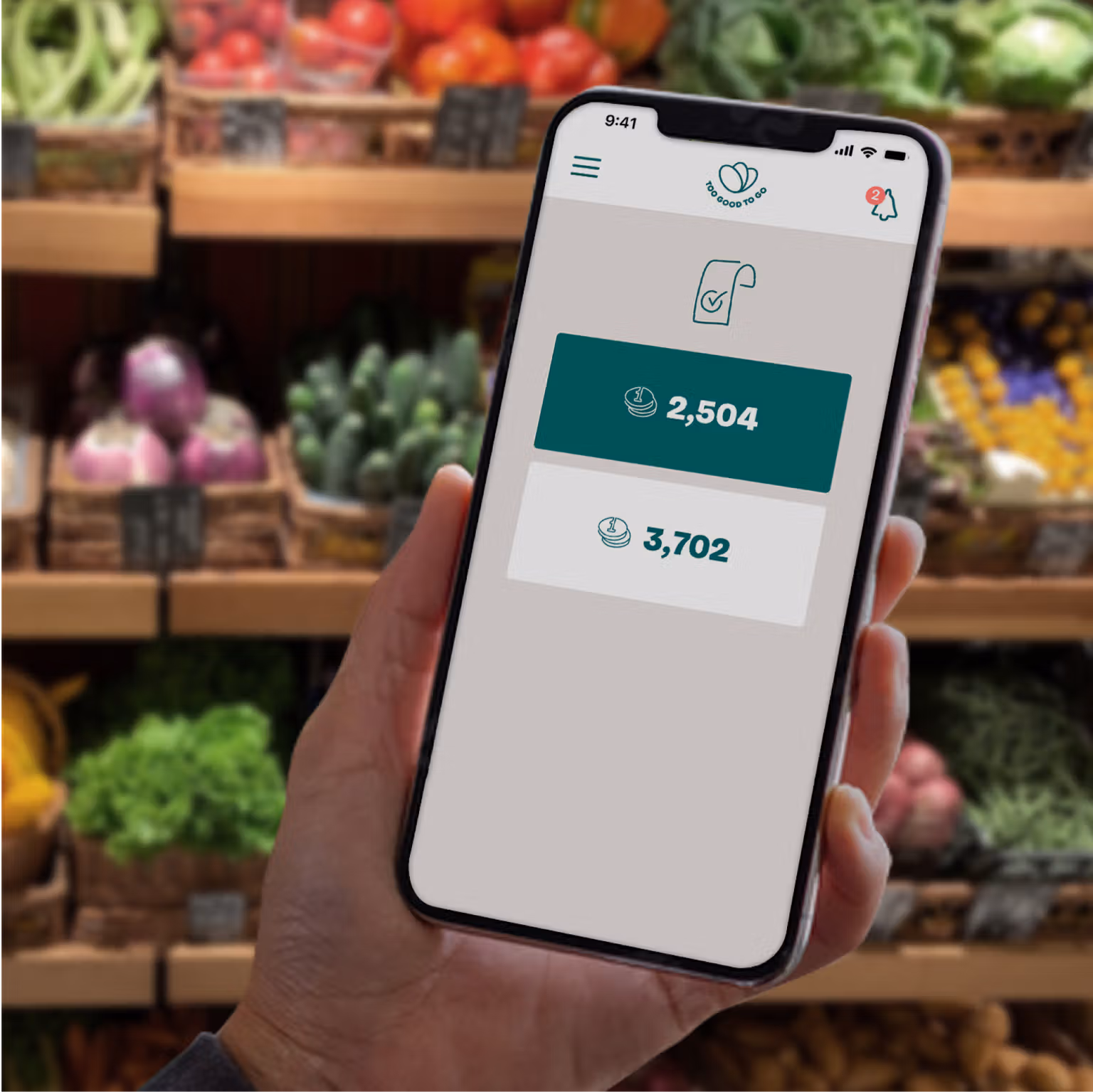a person is holding a cell phone in front of a grocery shelf